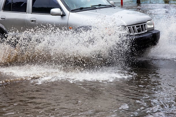 Car driving through flooded street