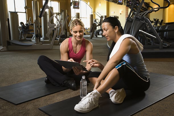 Personal trainer and her client at the gym