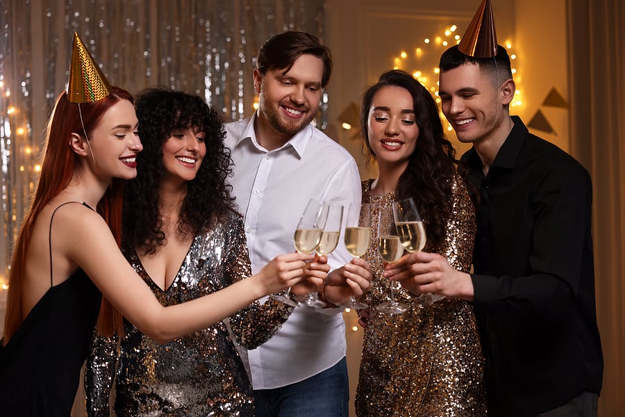 people at holiday party toasting with champagne