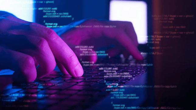 hand typing on keyboard with coding 