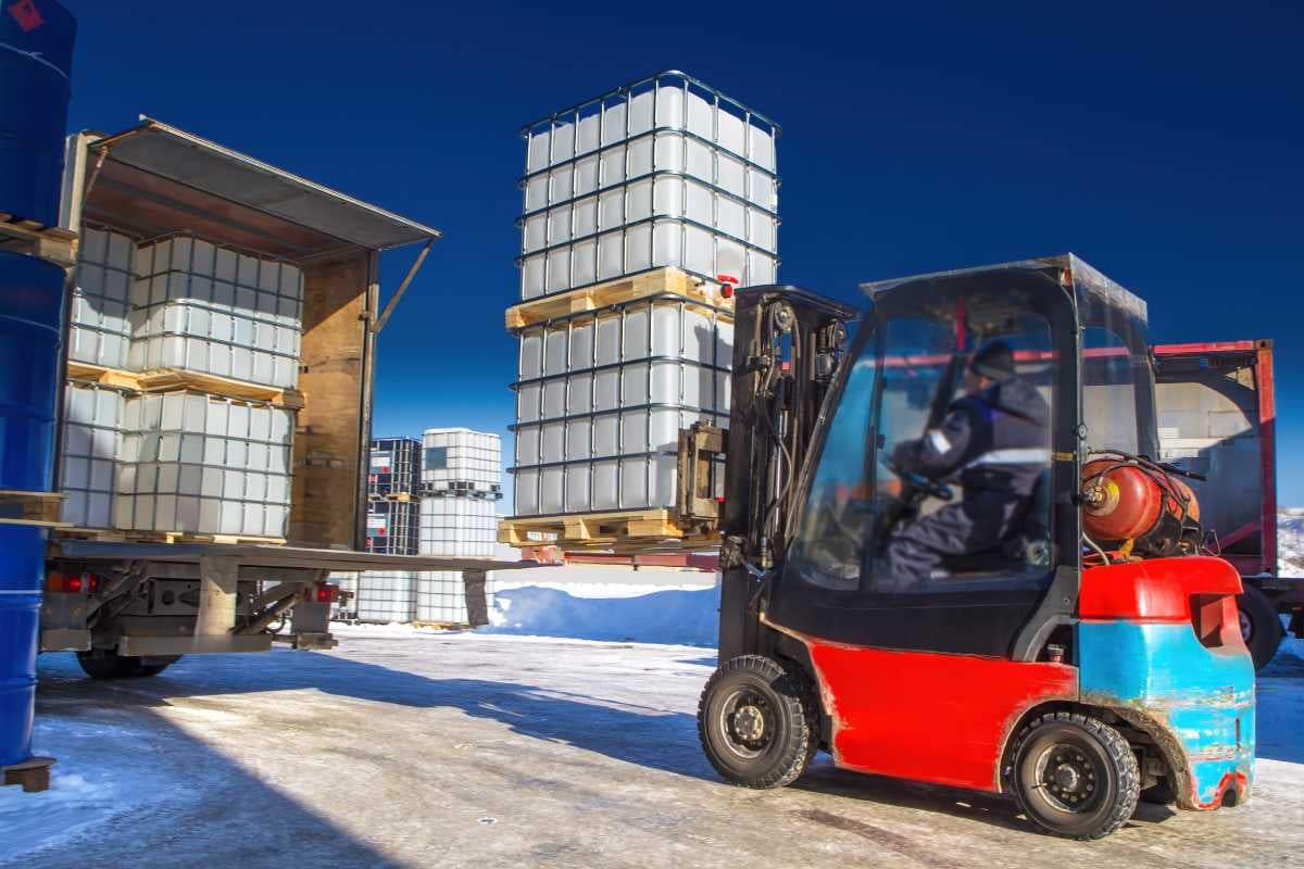 Forklift loading truck with commercial goods to be transported inland 